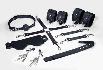 Feral Feelings BDSM Kit 7 Black, handcuffs, leggings, connector, mask, paddle, gag, clamps