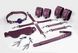 Feral Feelings BDSM Kit 7 Burgundy, handcuffs, leggings, connector, mask, paddle, gag, clamps